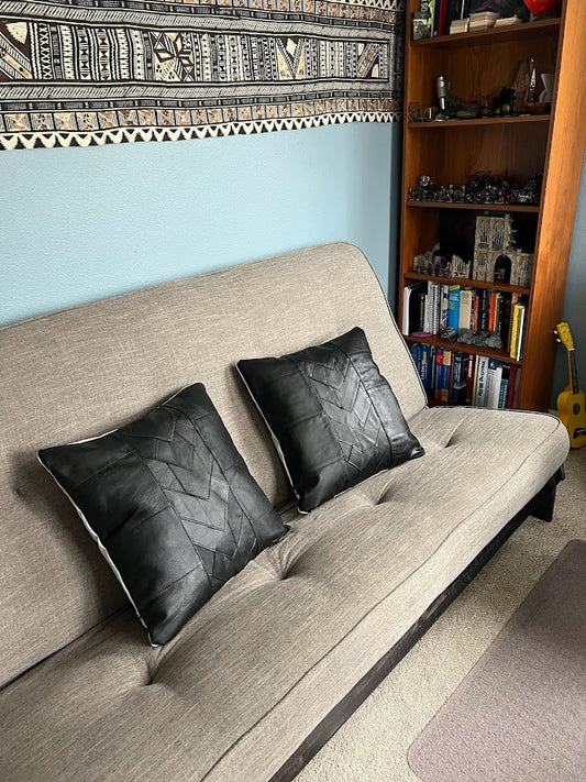 Black leather patchwork pillows add accent to streamlined couch and office.