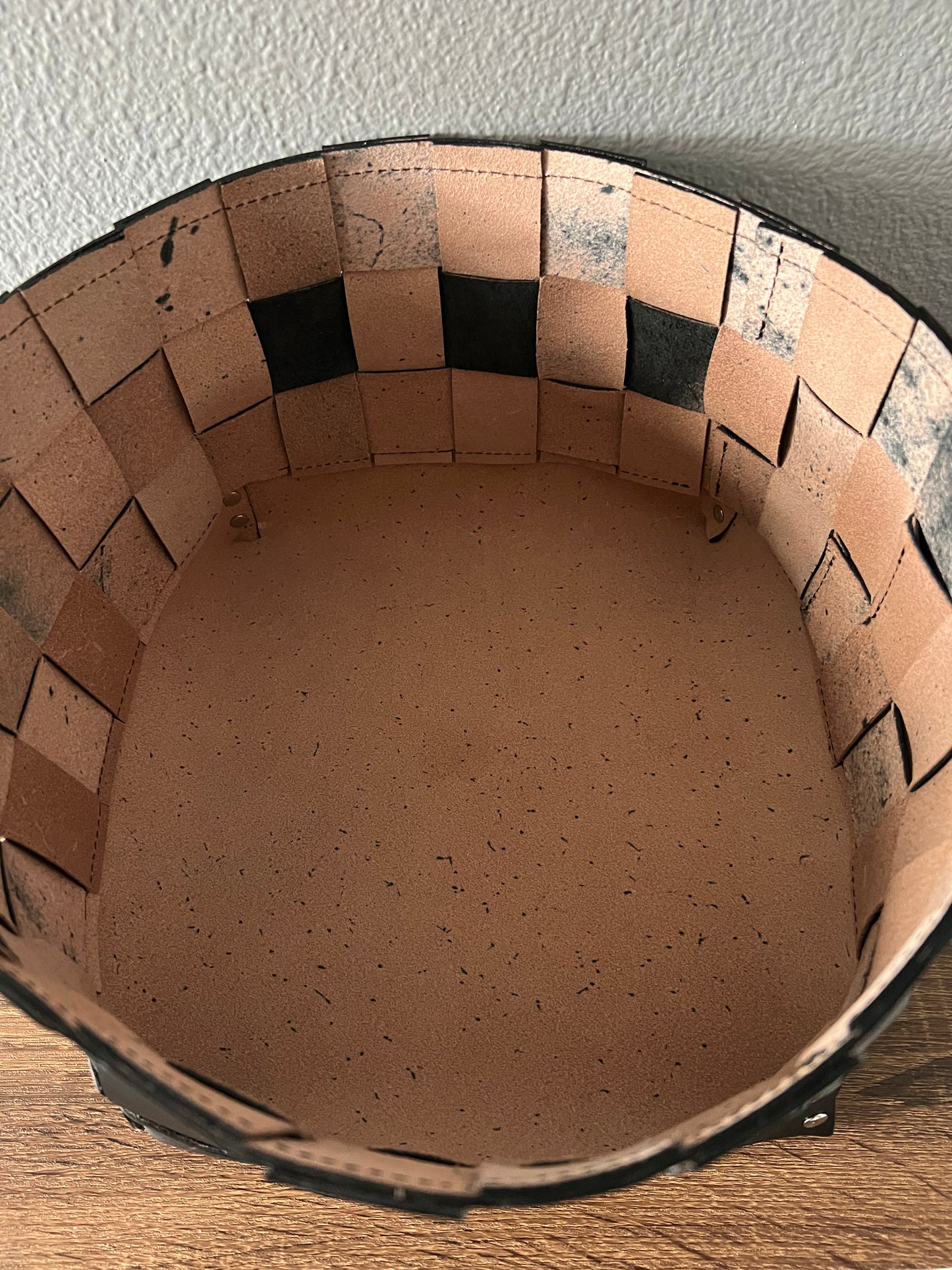 Interior view of hand woven leather bin.