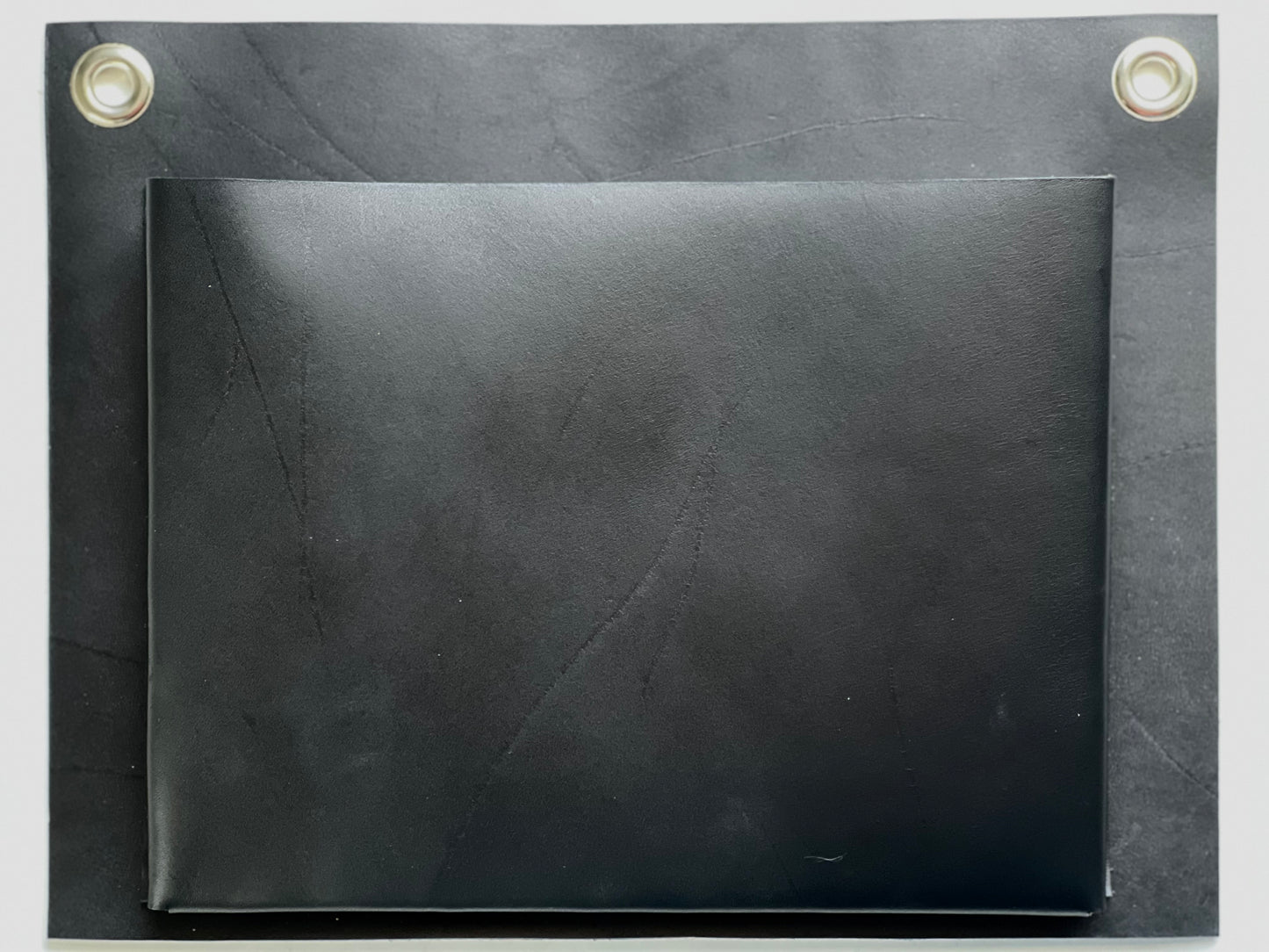 Close up of rich leather detail on black wall pocket.