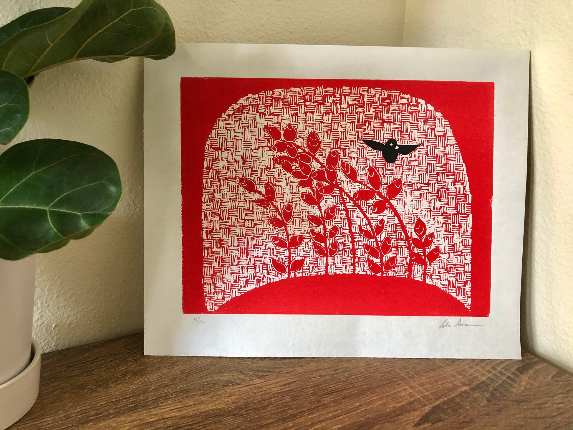 Cheerful red nature print with black bird in flight.