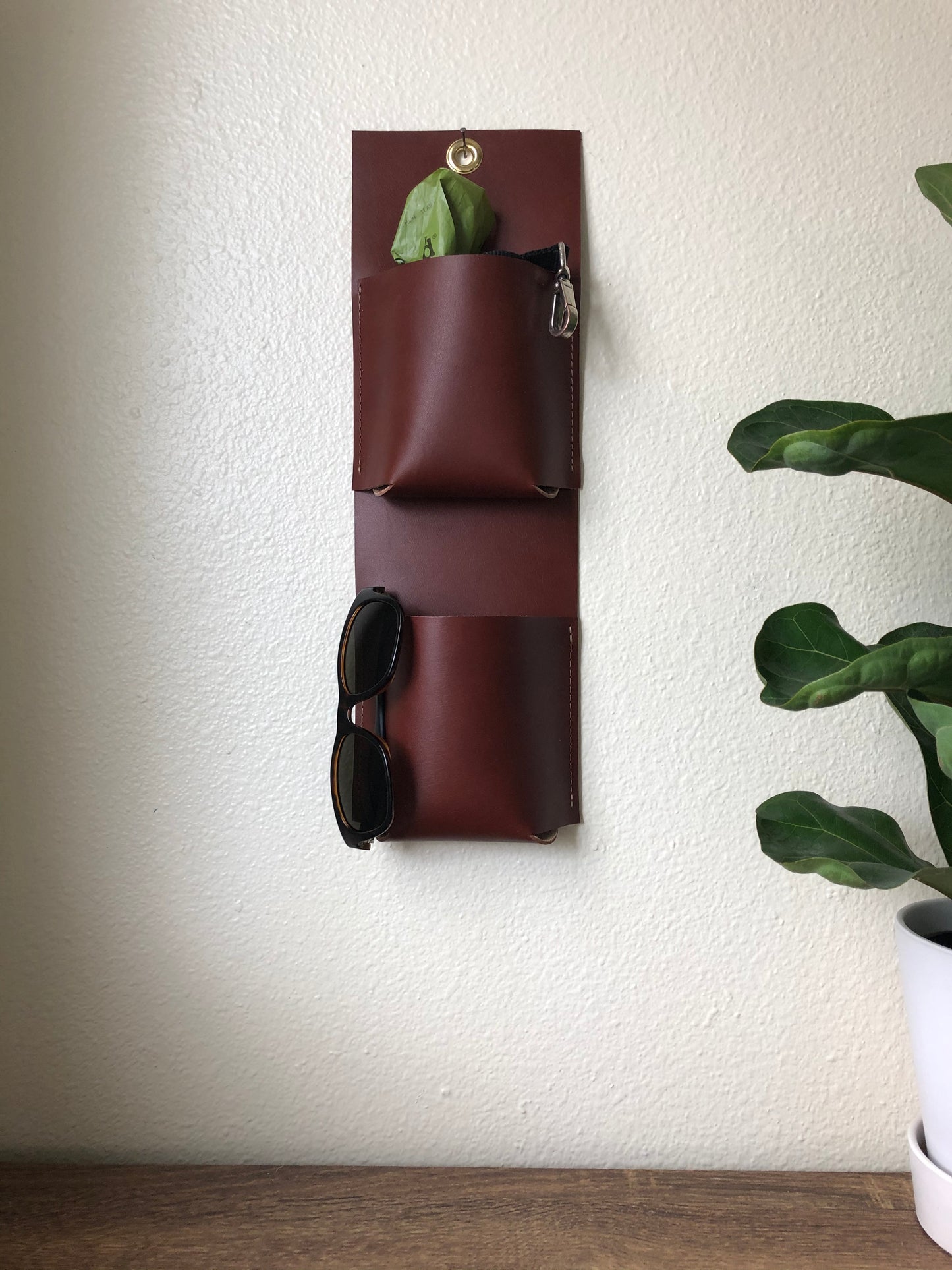 Rich leather wall pockets hold sunglasses and dog leash and bags stylishly.